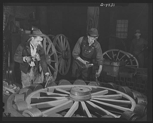 Production. Wagon wheels. Revival of a dying art. Fitting the steel tire to the wagon wheel assembly in the plant of a Southern wagon company which is experiencing a business boom because of the rubber shortage