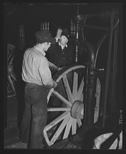 Production. Wagon wheels. Wagon wheels in the making. Workers in a Southern wagon plant countersinking steel tire which has been attached to wheel assembly. Wagon wheel making is having a boom business because of the rubber shortage