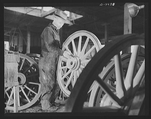 Production. Wagon wheels. Revival of a dying art. Applying the finishing touches to a completed wagon wheel in the painting room of a Southern wagon wheel company which is swamped with orders because of the rubber shortage