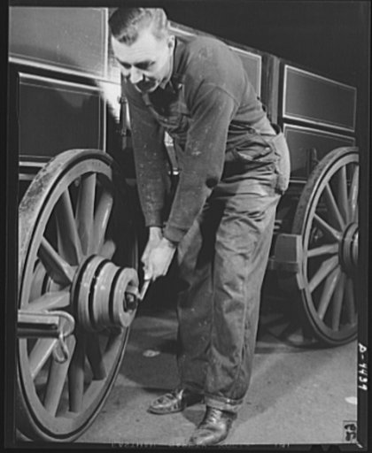 Production. Wagon wheels. From the wagon assembly of a Southern wagon plant comes this once familiar vehicle which is being built in great volume these days as a result of the rubber shortage. This worker is giving a farm wagon the final once-over