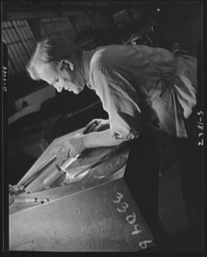 Conversion. Auto parts to aircraft landing gear. The finishing touches in the making of a precision die are done by hand by this expert toolmaker in a large auto plant which has converted to the production of aircraft landing gear