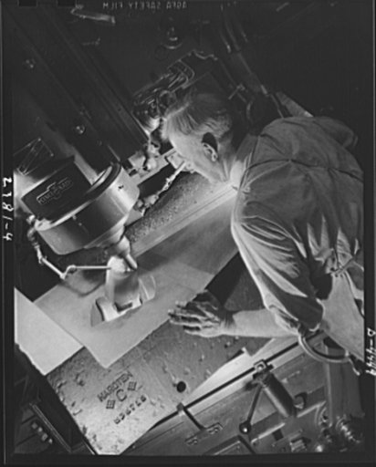 Conversion. Auto parts to aircraft landing gear. Like a sculptor working in marble, this toolmaker is carving a die (a process known as diecasting) from a piece of solid steel for use in the production of forgings for aircraft landing gear. The machining is being done in a converted Midwest automobi