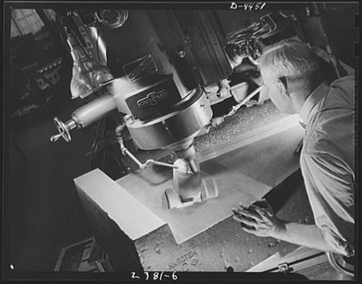 Conversion. Auto parts to aircraft landing gear. Like a sculptor working in marble, this toolmaker is carving a die (a process known as diecasting) from a piece of solid tool steel for use in the production of forgings for aircraft landing gear. The machining is being done in a converted Midwest aut