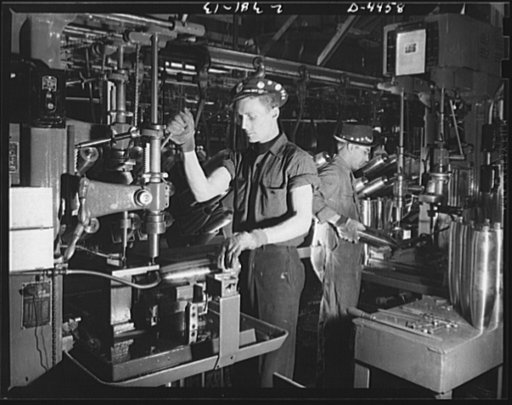 Conversion. Auto parts to artillery shells. A drilling operation on the noses of artillery shells is performed with speed and efficiency in a converted Midwest auto plant. Continuous conveyers feed the shells to the operators to ensure steady production
