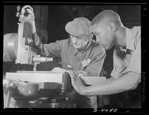 Manpower. Negro navy yard workers. From the aged and the youthful, from the white and the Negro come the skills which will make America impregnable. A veteran employee in an Eastern navy yard instructs an apprentice machinist in the operation of an important machine
