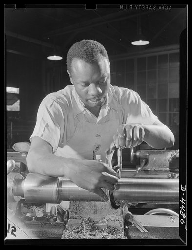 Manpower. Negro navy yard workers. Thomas Walker, one of the many Negro workers employed in the aircraft factory of a larger Eastern navy yard, contributes to the happy landings of our air warriors. Walker is shown working on olios, a part of the landing gear of fighting craft