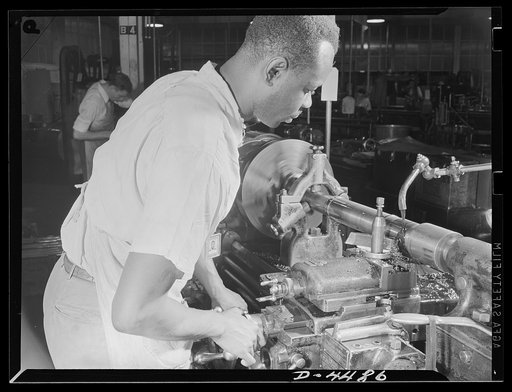 Manpower. Negro navy yard workers. Thomas Walker, one of the many Negro workers employed in the aircraft factory of a larger Eastern navy yard, contributes to the happy landings of our air warriors. Walker is shown working on olios, a part of the landing gear of fighting craft