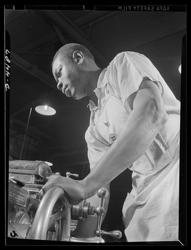 Manpower. Negro navy yard workers. Thomas Walker, one of the many Negro workers employed in the aircraft factory of a larger Eastern navy yard, contributes to the happy landings of our air warriors. Walker is shown working on olios, a part of the landing gear of fighting craft