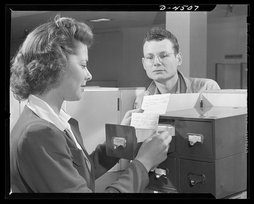 Car pooling at Lockheed Vega. Equipped with a filing system arranged by neighborhood sections, the transportation clerk soon locates a driver who has room for extra passengers