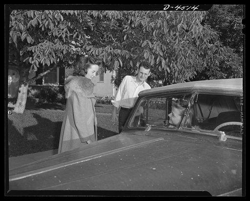 Car pooling at Lockheed Vega. Resuming their homeward drive, Jerry stops the car for Mary, the first out. She lives about six miles from the plant