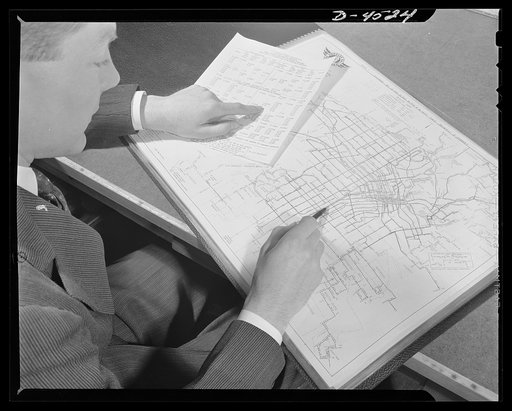 Car pooling at Lockheed Vega. New bus railheads are established just as quickly as enough employees apply for transportation to justify it. Here, a transportation expert plots new bus routes