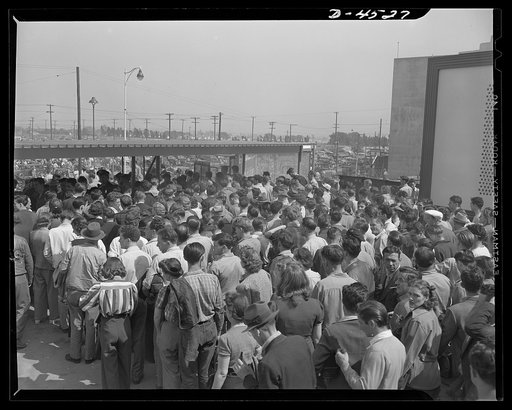 Car pooling at Lockheed Vega. Here is part of the day shift leaving one of Vega's nine gates at the main plant. Note the high proportion of women workers. Getting these employees and their thousands upon thousands of brother and sister workers between home and plant is becoming a serious problem. Pr