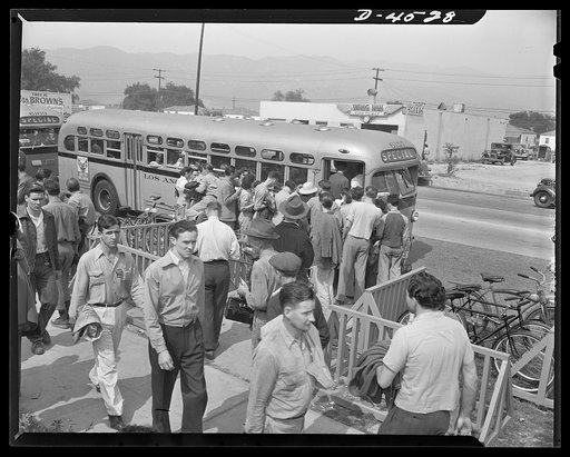 Car pooling at Lockheed Vega. Outside the plant gate, they wait for busses like this one. Eighty-four busses of this type have been placed in service in about six weeks, and more are being added continually. Busses will make the circuit of all the gates, stopping a few minutes at each, then making a