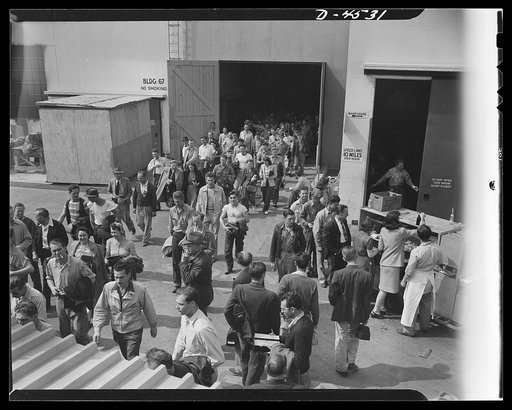 Car pooling at Lockheed Vega. Day shift leaving gate no. 4. Lockheed Vega aircraft plant. Company employees travel home by special Lockheed-chartered busses, by pooling their automobiles and by bicycles