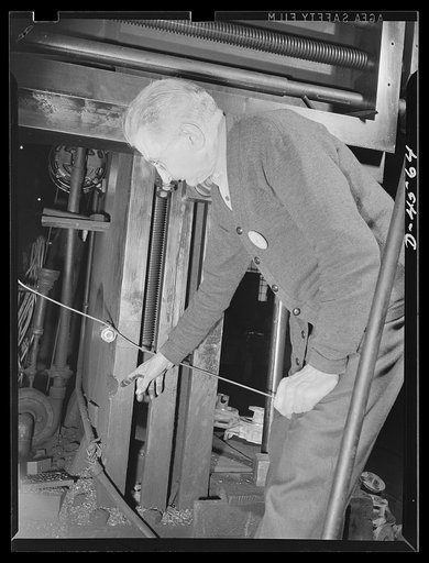 Manpower. Veteran boring mill worker. Seventy-five-year-old George Shoemaker points to the only change ever made in the seventy-seven-year-old vertical boring mill on which he has worked for the past fifty-four years. The groove was cut to accomodate huge castings of lighthouse settings many years a