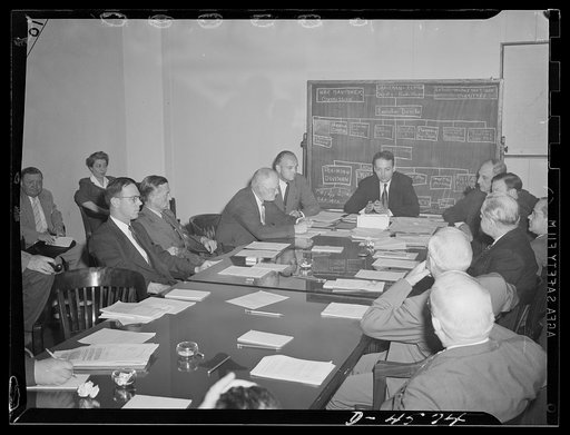 Management labor policy committee of the War Manpower Commission at its first meeting. Arthur S. Flemming, chariman of the committe, at far end of table is presiding. Seated to his left are the members representing management, and on his right representing labor