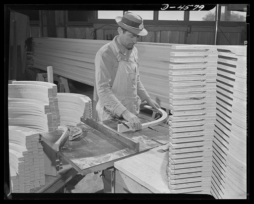 Production. War housing trailers. Curved roof bows are carefully trimmed to ensure that each will fit exactly in the roof assembly. Modern power equipment figures largely in the manufacturing plant of the Western Trailer Company of Los Angeles
