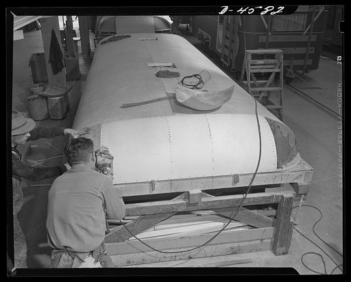 Production. War housing trailers. The top of a war housing trailer is assembled and finished in the Los Angeles plant of Western Trailer Company. Corners are plastic, rounded sections made of paper especially treated to give it great hardness and durability