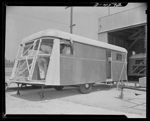 Production. War housing trailers. A war housing trailer takes shape at the Los Angeles plant of Western Trailer Company. Frame members have already been installed at the rear of this trailer, and the top is set in place. A new chassis is already in place at the right, ready to receive stringers