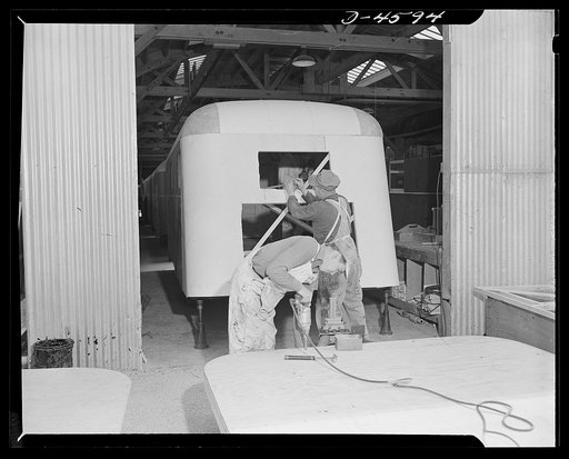 Production. War housing trailers. A war housing trailer moves onto the assembly line of Western Trailer Company at Los Angeles. The chassis of the next trailer, in the foreground, is almost ready to receive sides