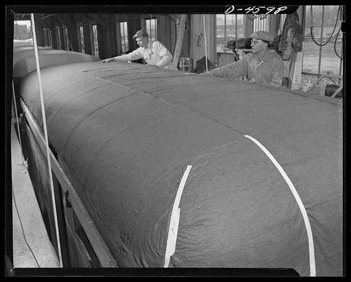 Production. War housing trailers. The top of a war housing trailer comes in for attention at the Los Angeles plant of Western Trailer Company. High catwalks give easy access to the top as blue wadding is laid over the entire surface. The spongy softness of this material will compress under the final