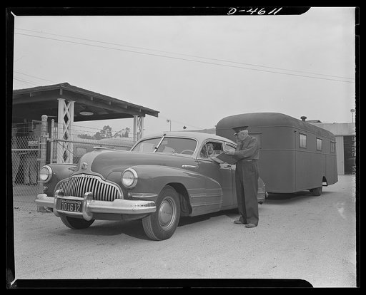 Production. War housing trialers. A completed war housing trailer is checked out at the Los Angeles plant gate of Western Trailer Company. It is destined for one of the West's critical housing areas. Individual trailers are hauled to nearby shipping points, then dispatched in convoys of ten to fifte