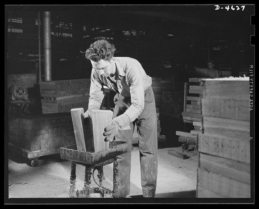 Conversion. Flooring to gunstocks. Selected pieces of walnut, carefully cut from large slabs of walnut -- and now known as gunstock butts -- are prepared for a kiln drying operation in a converted hardwood flooring plant. The ends are dipped in a solution of resin and paraffin to prevent checking (s