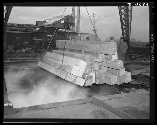 Production. Veneer for aircraft and other war essentials. Torpedo boats need veneer of Philippine mahogany, which will be cut from these slabs, or flitches. A sling-load of quarter flitches being lowered into a heating vat in preparation for knife slicing at a Midwest veneer plant. Louisville, Kentu