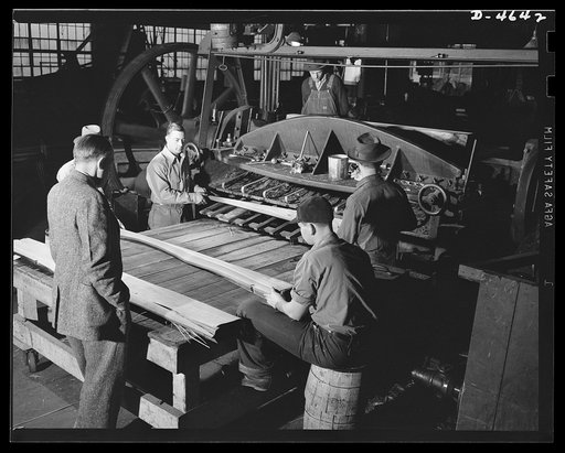 Production. Veneer for aircraft and other war essentials. Veneer for combat planes. In the "half-round method," a half log, after being heated in water to the proper temperature, is bolted on a stay log and revolved against a stationary knife. The sheets, as they fall from the knife, are stacked in 