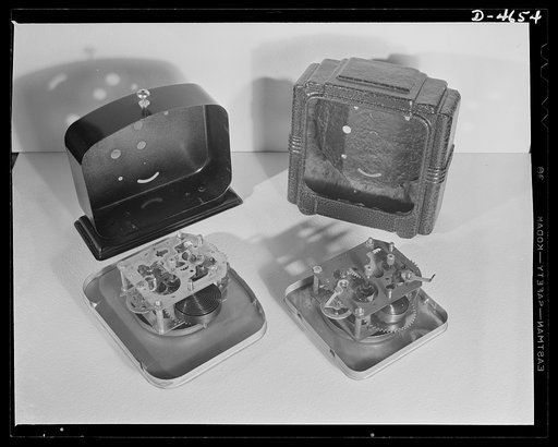 Substitutes. Composition clock cases. New clock conserves critical metals. Two-bit model (right) produced by Gilbert Clock Corporation, compared with metal-case model which sold under the same guarantee. Saves brass, aluminum, phosphor, bronze and steel --and eases the transportation problem by redu