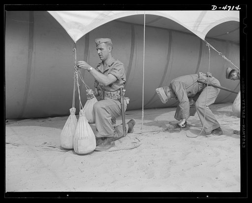 Parris Island. Marine Corps barrage balloons. Bedding down a big barrage balloon is just another job that the leathernecks take in stride as special marine units are trained at Parris Island, South Carolina. "Purging" it with fresh gas before it goes aloft again and running it up into a tactical for