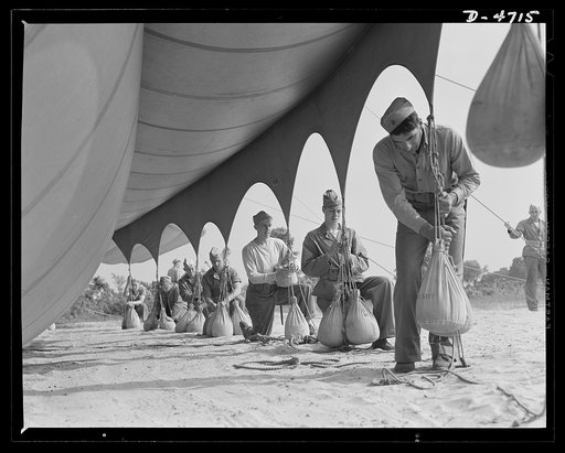Parris Island. Marine Corps barrage balloons. Bedding down a big barrage balloon is just another job that the leathernecks take in stride as special marine units are trained at Parris Island, South Carolina. "Purging" it with fresh gas before it goes aloft again and running it up into a tactical for