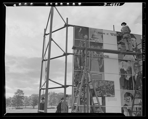 Four Freedoms and Arsenal of Democracy posters. Assembly workers have nearly finished setting up the huge 15 x 30 foot photomontage The Four Freedoms. On the other side of the scaffolding was the Arsenal of Democracy panel, equal in size. The two were displayed in Defense Square, Washington for a mo