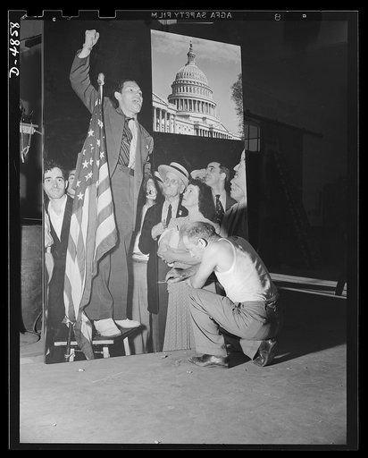 And, furthermore, ladies and gents -- at any rate, that's what the speaker might be saying. We wouldn't know. He is merely part of a 5 x 7 1/2 foot section of the Four Freedoms panel on display at Grand Central Palace, New York at the National and Civiliab Defense Exposition. This panel, 15 x 30 fee
