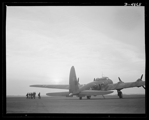 Langley Field, Virginia. YB-17 bombardment squadron. Duck patrol. A combat crew marches toward a giant YB-17 bomber to begin a patrol flight from Langley Field, Virginia
