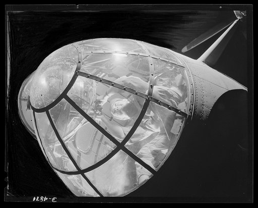 Langley Field, Virginia. YB-17 bombardment squadron. In the transparent nose of a mighty YB-17 bomber, a sergeant of a bombardment squadron stationed at Langley Field, Virginia handles the machine gun
