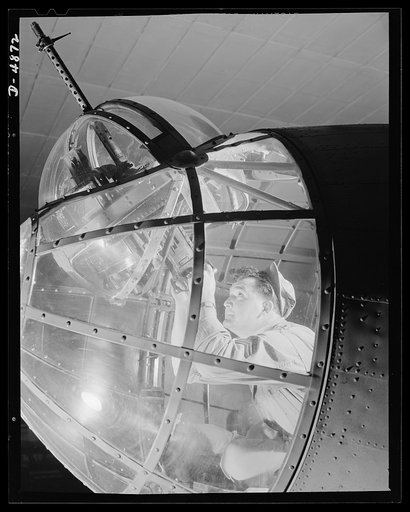 Langley Field, Virginia. YB-17 bombardment squadron. In the transparent nose of a mighty YB-17 bomber, a sergeant of a bombardment squadron stationed at Langley Field, Virginia handles the machine gun