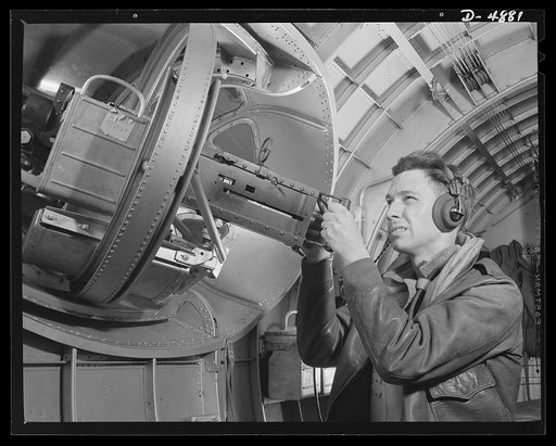 Langley Field, Virginia. YB-17 bombardment squadron. Hitler would like this man to go home and forget about the war. A good American non-com at the side machine gun of a huge YB-17 bomber is a man who knows his business and works hard at it