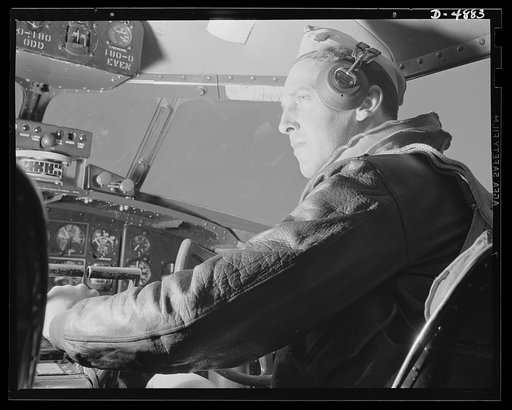 Langley Field, Virginia. YB-17 bombardment squadron. A lieutenant of a bombardment squadron stationed at Langley Field, Virginia checks his instruments before taking off in a mighty YB-17 bomber on which he is co-pilot