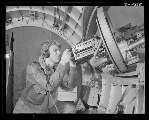 Langley Field, Virginia. YB-17 bombardment squadron. Hitler would like this man to go home and forget about the war. A good American non-com at the side machine gun of a huge YB-17 bomber is a man who knows his business and works hard at it