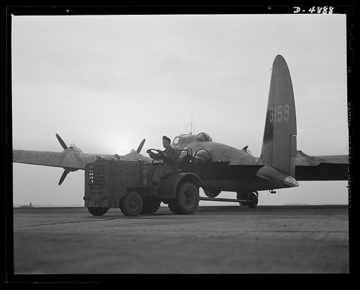 Langley Field, Virginia. YB-17 bombardment squadron. One of Uncle Sam's mighty warships of the air is berthed at Langley Field, Virginia. A tow-car returns a YB-17 bomber to a hanger of the bombardment squadron for which it has just completed a mission
