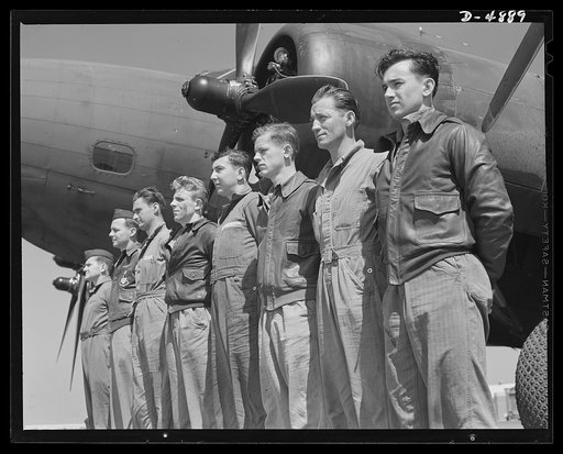 Langley Field, Virginia. YB-17 bombardment squadron. A combat crew of one of our mighty YB-17 bombers lines up before a warship of the skies. A captain and lieutenant act as pilot and co-pilot. Two sergeants and four corporals man the machine guns, radio and other equipment. All belong to a bombardm