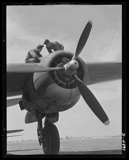 Langley Field, Virginia. YB-17 bombardment squadron. Two members of a ground crew at Langley Field, Virginia services one of the four powerful engines of a YB-17 bomber. The huge engine nacelle and landing wheel give some idea of the masiveness of this warship of the skies