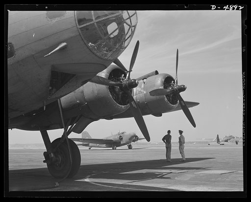 Langley Field, Virginia. YB-17 bombardment squadron. There's plenty of traffic on the runways of a bombardment squadron base. A plane taxis in after landing at Langley Field, Virginia. In the foreground is a giant YB-17 bomber with the transparent gunner's port and two of the four powerful engines s