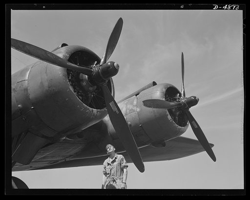 Langley Field, Virginia. YB-17 bombardment squadron. The men who keep them flying are proud of Uncle Sam's new warships of the skies. A master sergeant of a bombardment squadron at Langley Field, Virginia turns a fond but critical eye on one of the four powerful motors of a giant YB-17 bomber