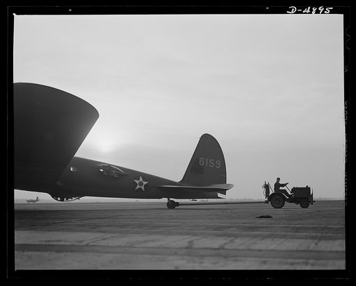 Langley Field, Virginia. YB-17 bombardment squadron. One of Uncle Sam's mighty warships of the air is berthed at Langley Field, Virginia. A tow car returning a YB-17 bomber to the hanger of the bombardment squadron for which it has just completed a mission