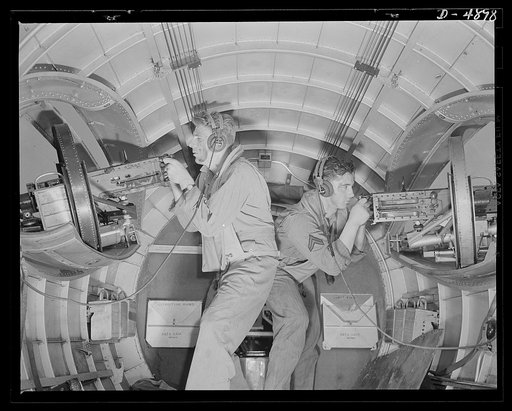Langley Field, Virginia. YB-17 bombardment squadron. Two good reasons why our air forces will be unpopular with the Axis. These corporals operating side machine guns in a mighty YB-17 bomber have developed into fast, accurate gunners