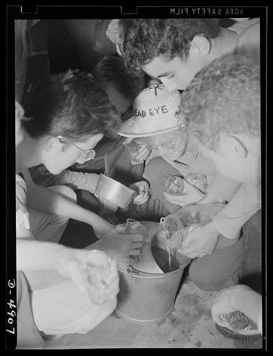 School boys training for agriculture. Time out for some well-earned refreshment. A group of high school boys prepare cooling lemonade supplied by the farm on which they are working. The training these lads are receiving will ease the farm labor situration and help toward winning the war and writing 