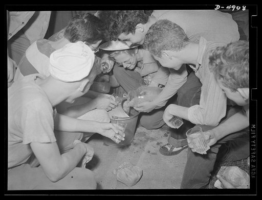 School boys training for agriculture. Time out for some well-earned refreshment. A group of high school boys prepare cooling lemonade supplied by the farm on which they are working. The training these lads are receiving will ease the farm labor situration and help toward winning the war and writing 