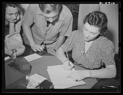School boys training for agriculture. Miss Mae E. Howard, manager, U.S. Employment Service at Silver Spring registers one of the 125 high school boys for training at nearby farms. After passing a physical exam, they will spend a whole summer helping local farmers. In return they receive 28 cents an 